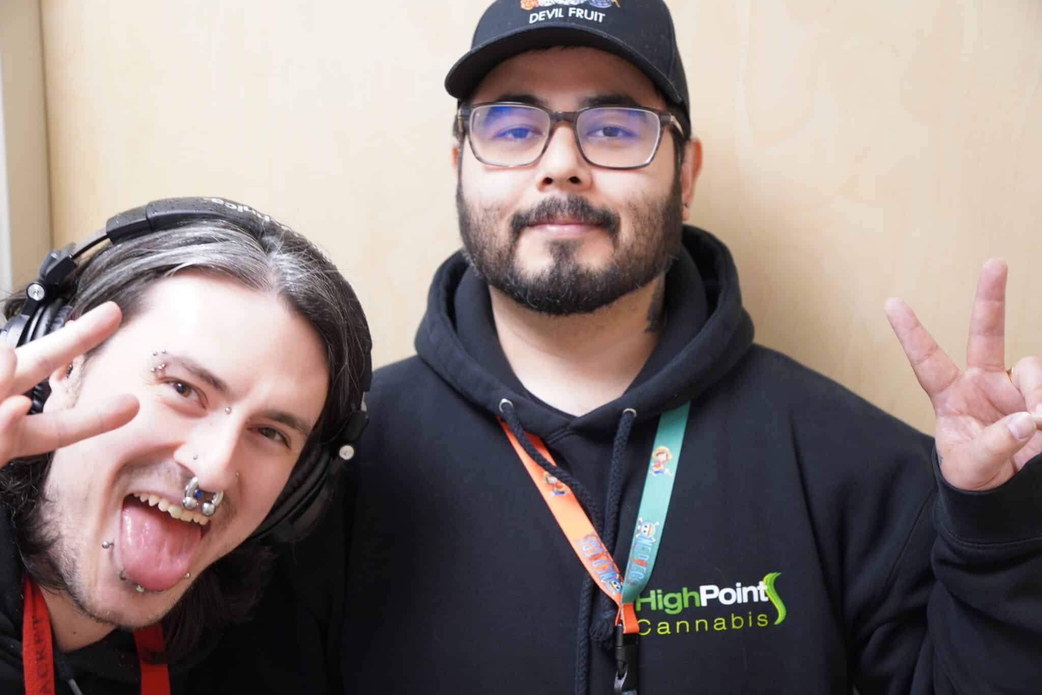 Two people posing with peace signs.