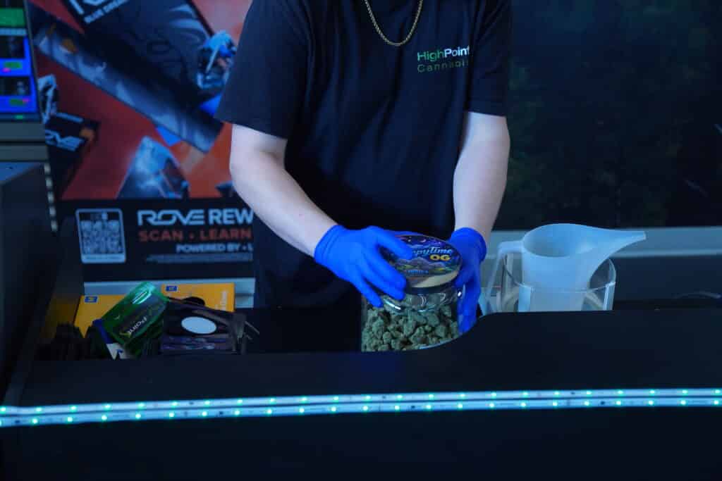Person handling cannabis products at counter