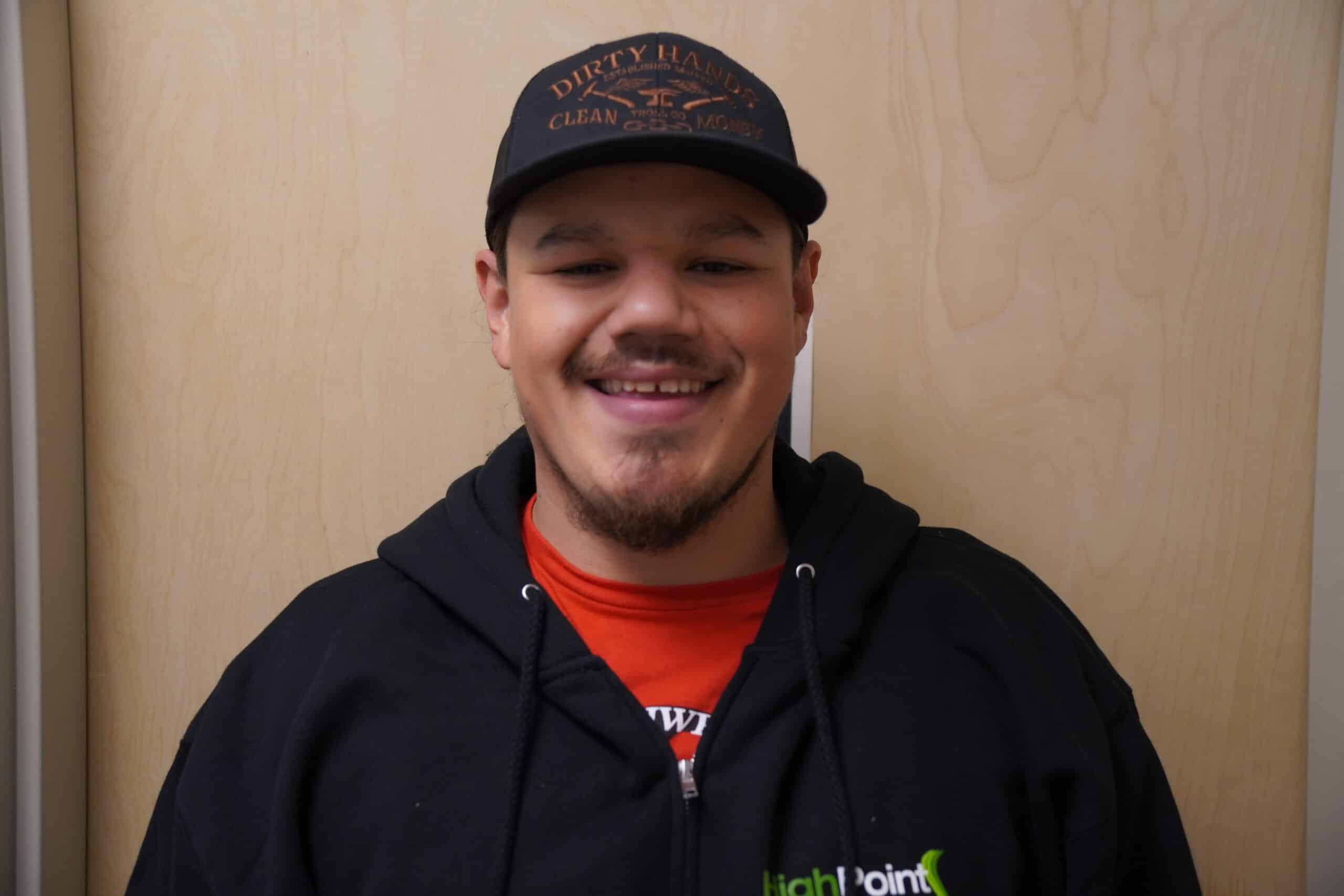Smiling man in black hoodie