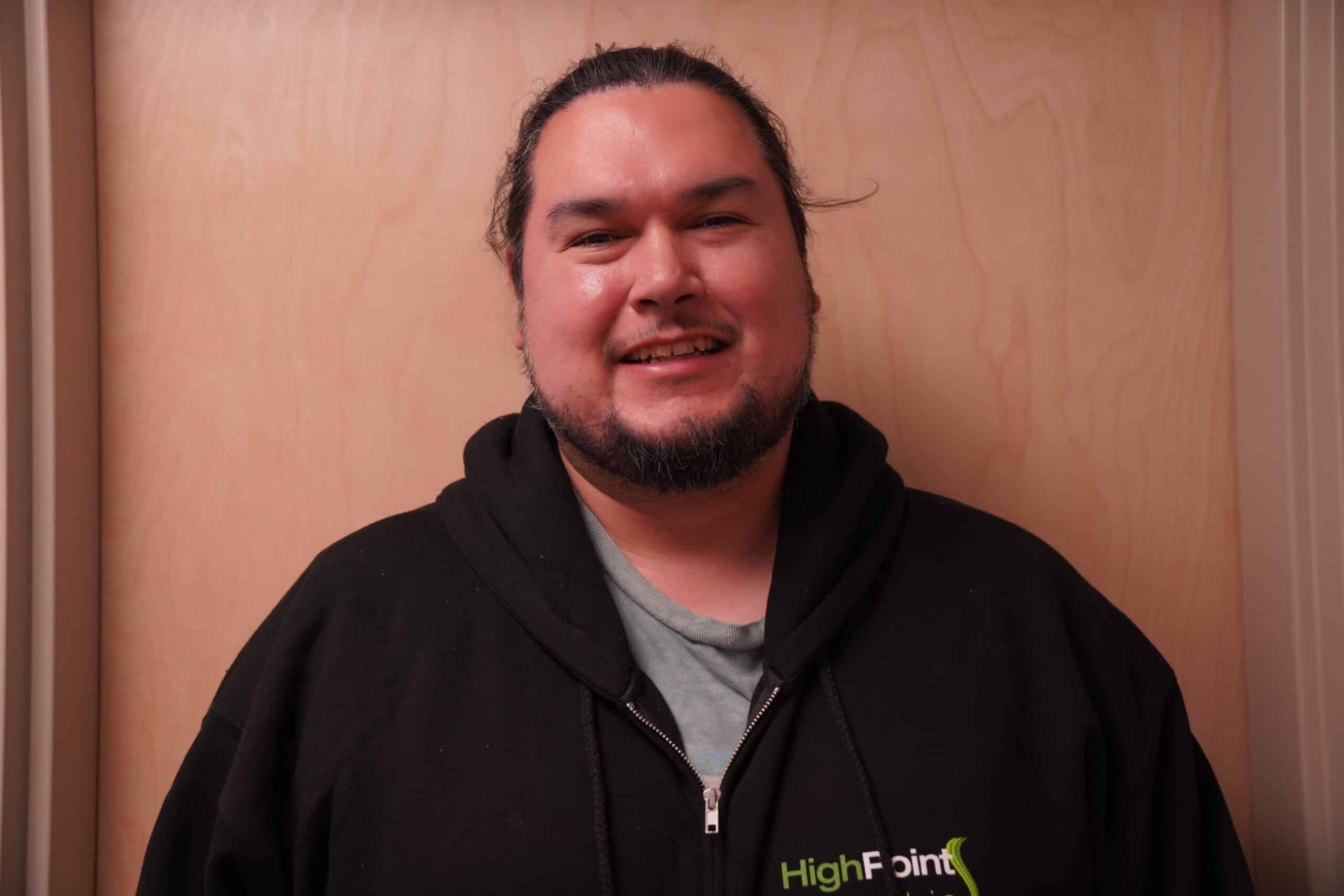 Smiling person in a hoodie